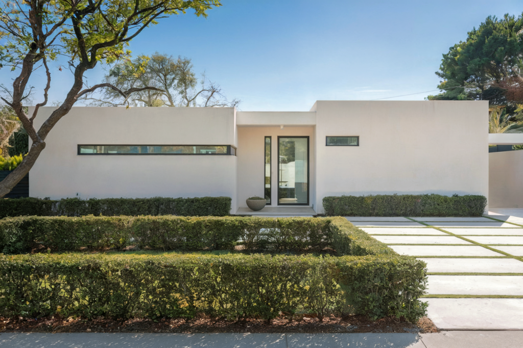 modern home with minimalist hedge accents.